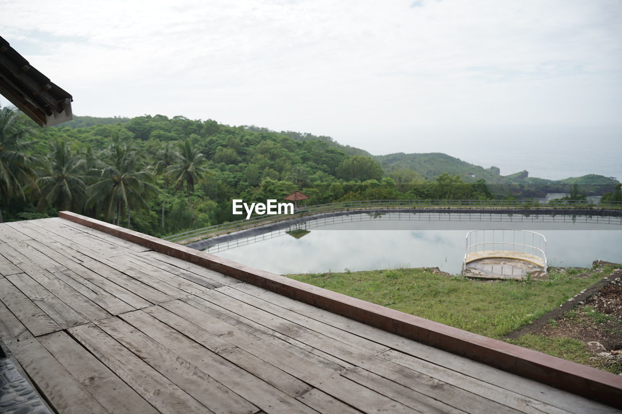 water, nature, wood, sky, architecture, plant, tree, lake, environment, scenics - nature, built structure, tranquility, no people, travel destinations, beauty in nature, landscape, mountain, reservoir, land, travel, trip, vacation, holiday, tranquil scene, day, outdoors, cloud, tourism, boardwalk, pier, bridge, walkway, summer, deck, beach, non-urban scene, relaxation, forest, tropical climate, house, idyllic