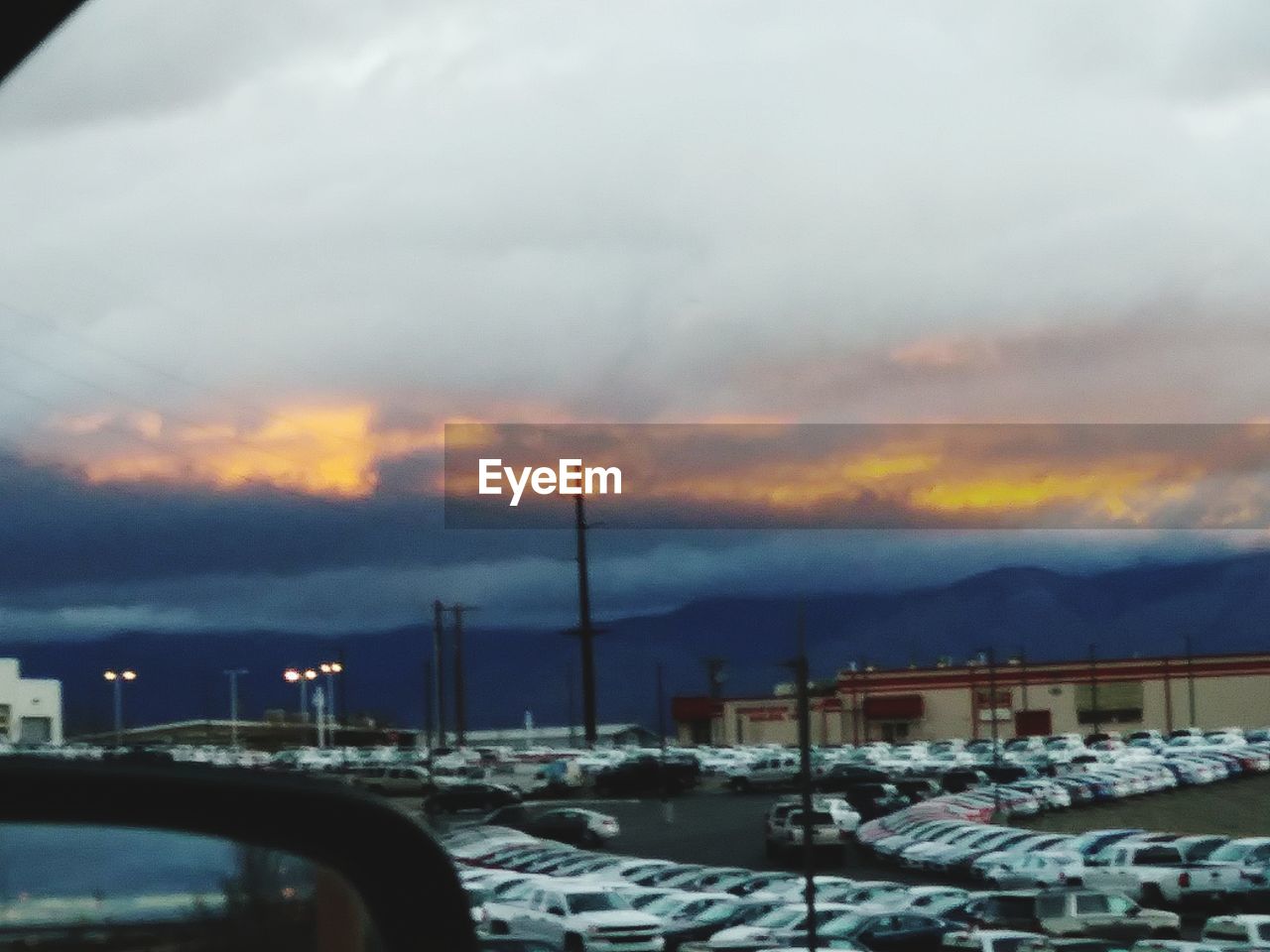 CARS ON ROAD AGAINST SKY IN CITY