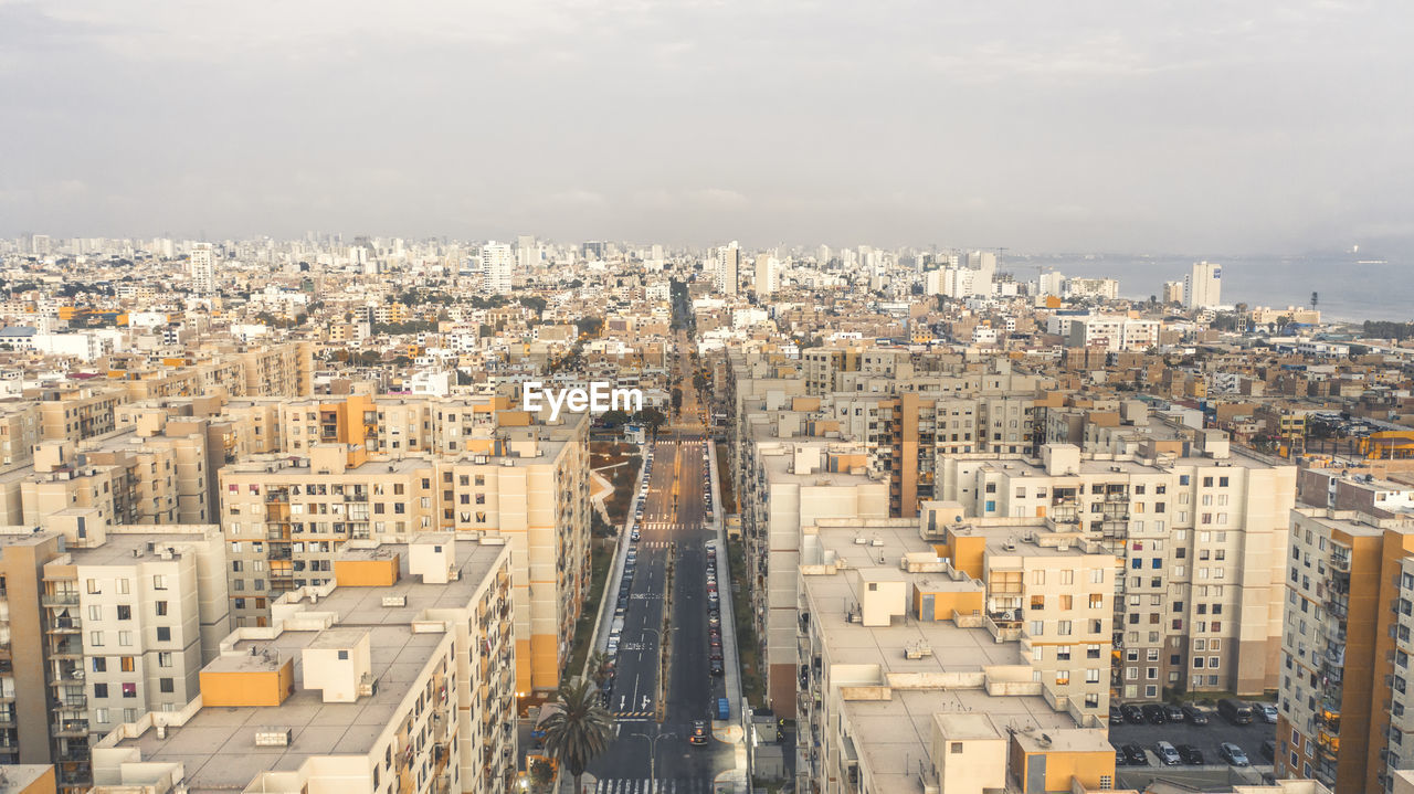 High angle view of city buildings against sky