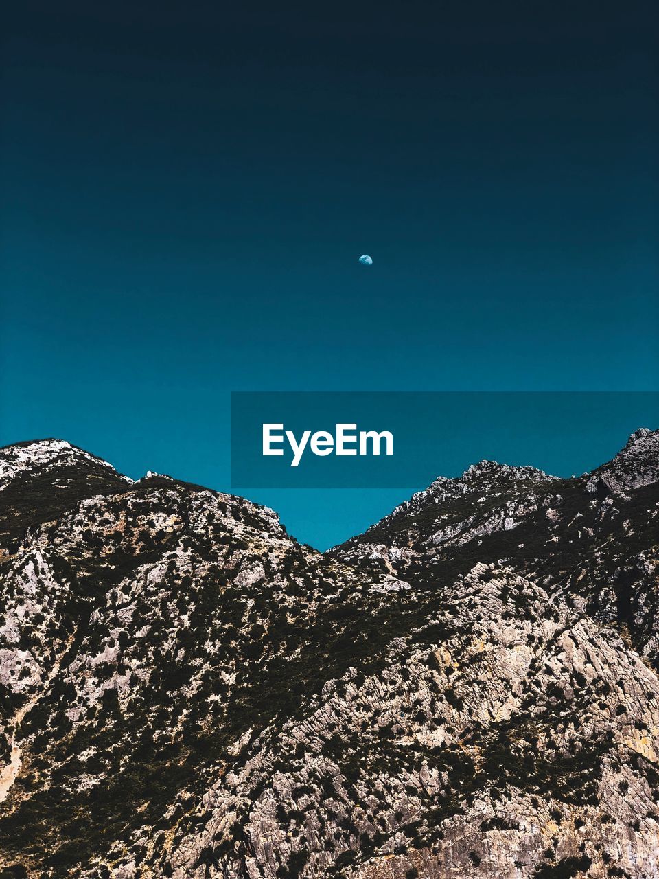 Low angle view of mountain against clear blue sky