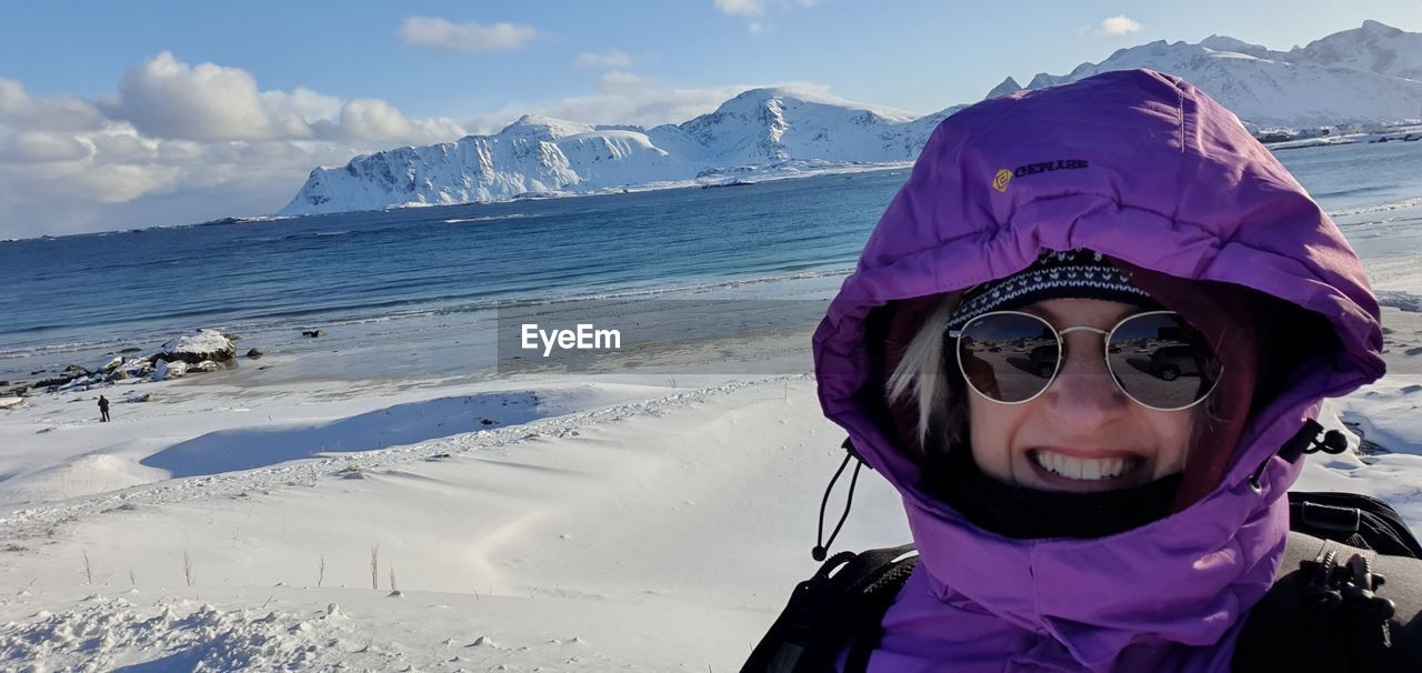 PORTRAIT OF WOMAN AGAINST SNOWCAPPED MOUNTAINS