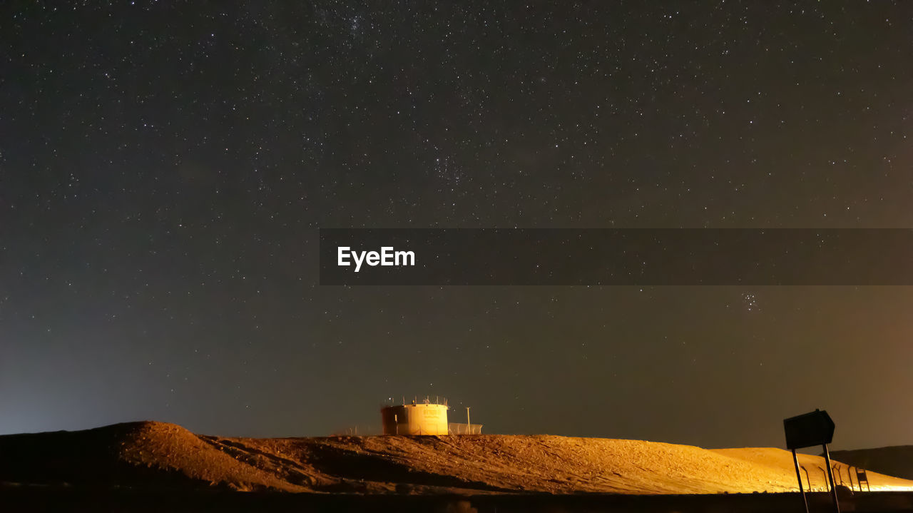 LOW ANGLE VIEW OF BUILDING AGAINST STAR FIELD