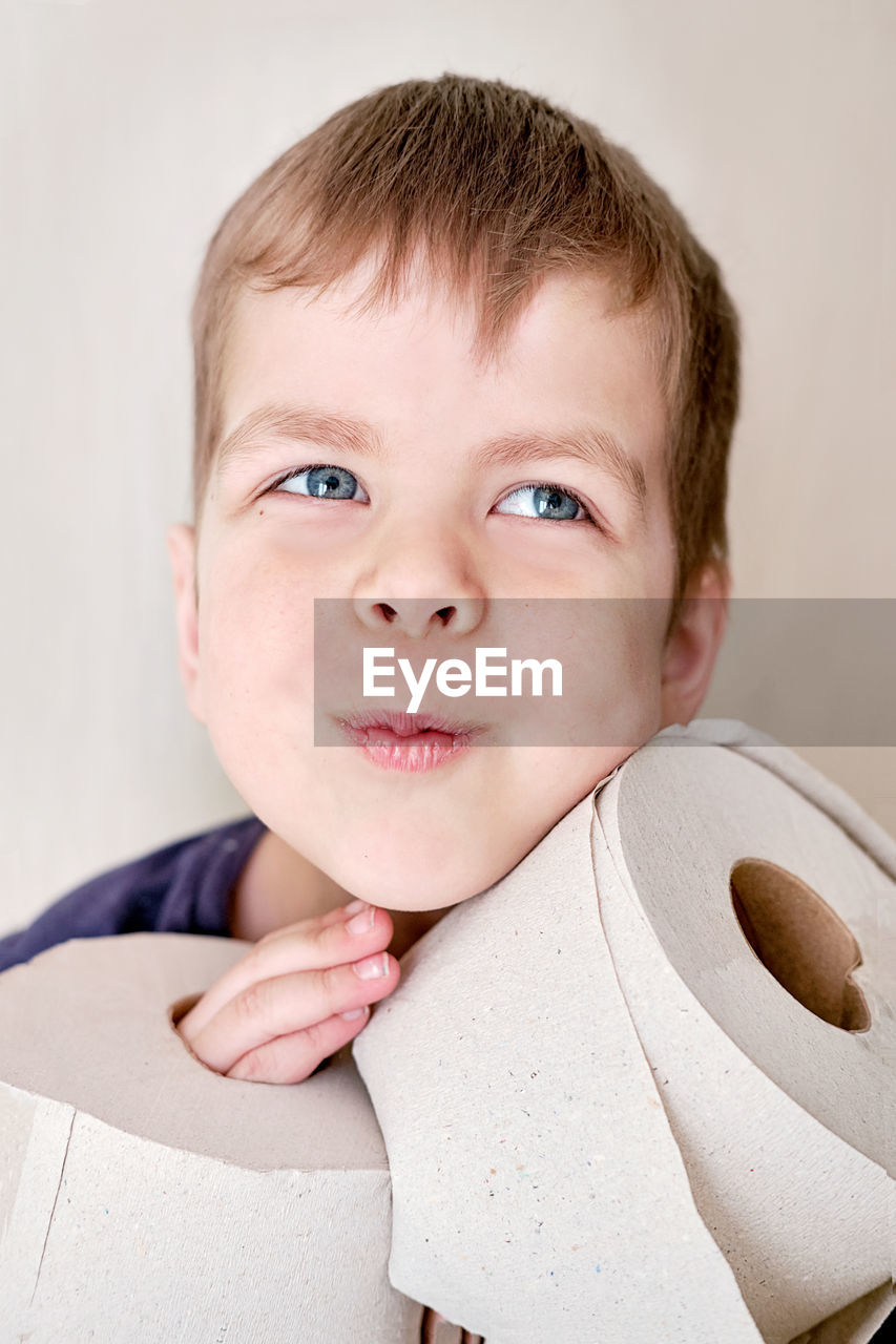 close-up portrait of cute baby boy sitting on bed