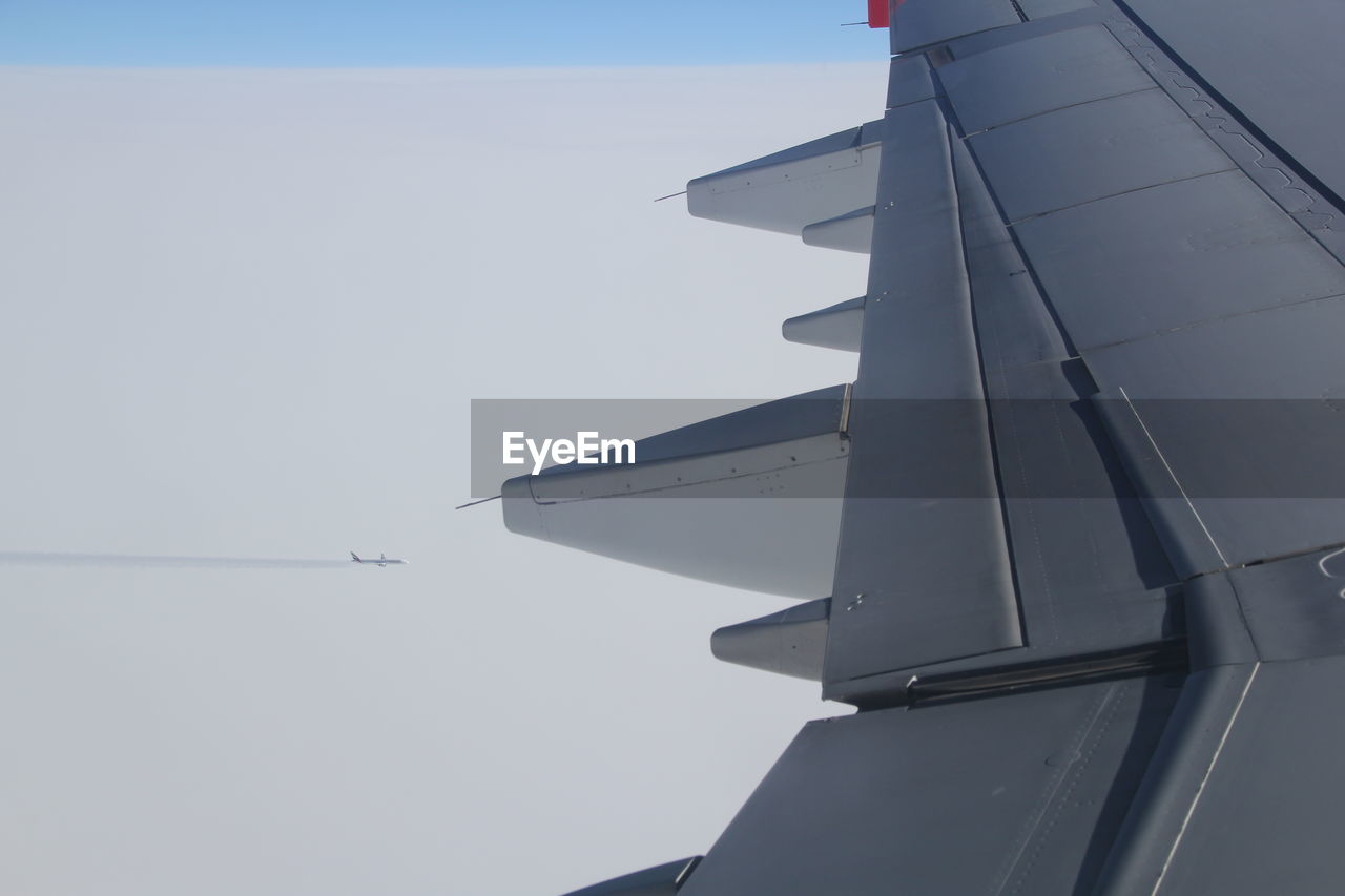 LOW ANGLE VIEW OF AIRPLANE FLYING OVER CLEAR SKY