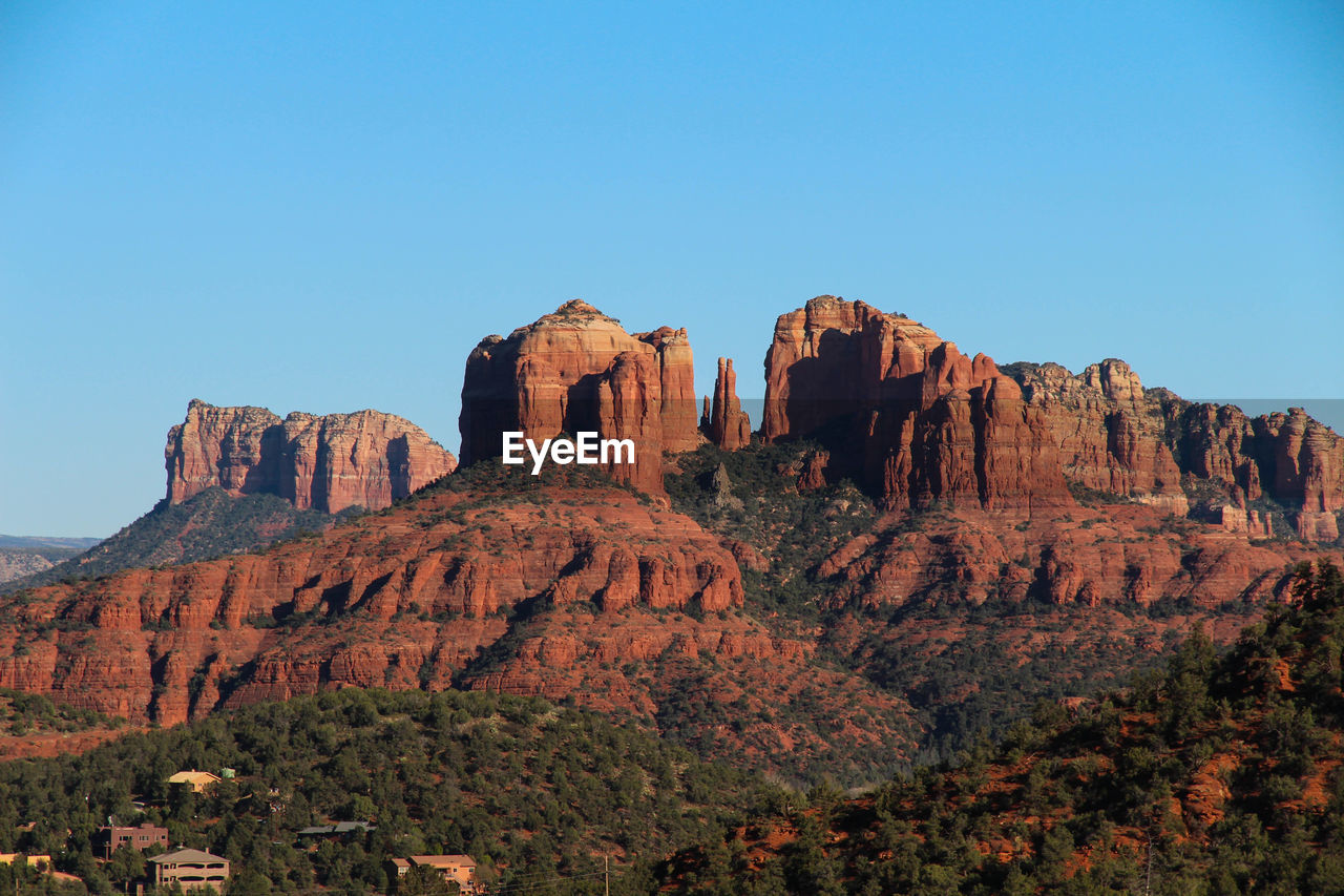 Rock formations on landscape against clear sky