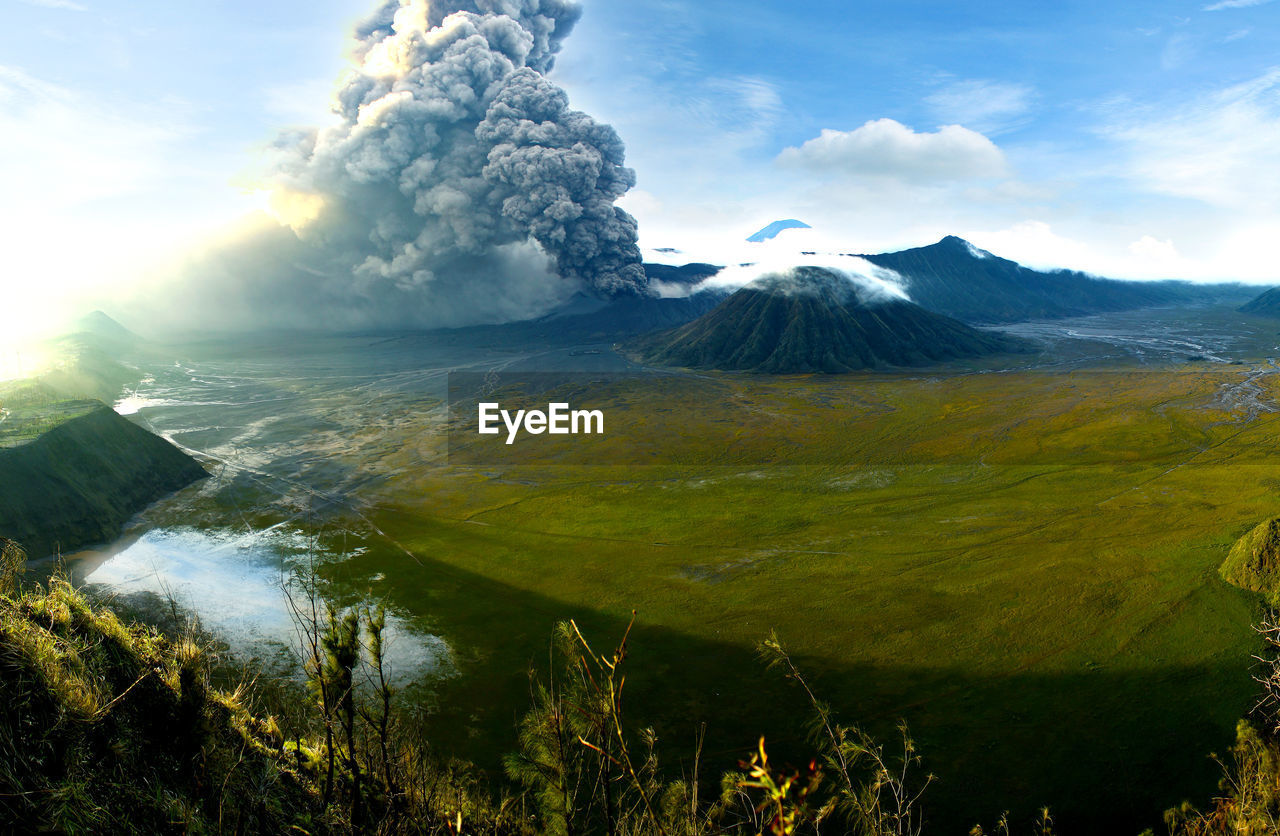 Smoke emitting from volcanic mountain against sky