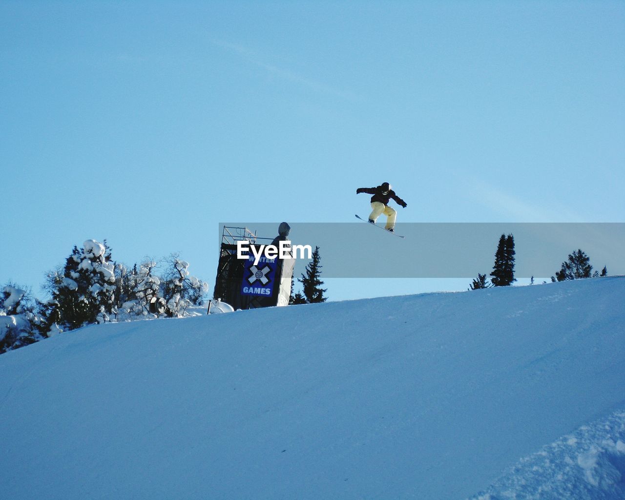 LOW ANGLE VIEW OF SNOW COVERED LANDSCAPE AGAINST BLUE SKY