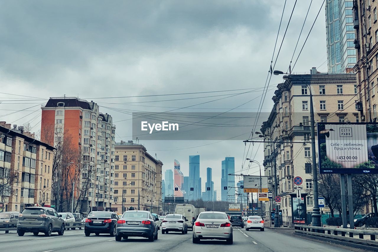 VIEW OF CITY STREET AND BUILDINGS AGAINST SKY