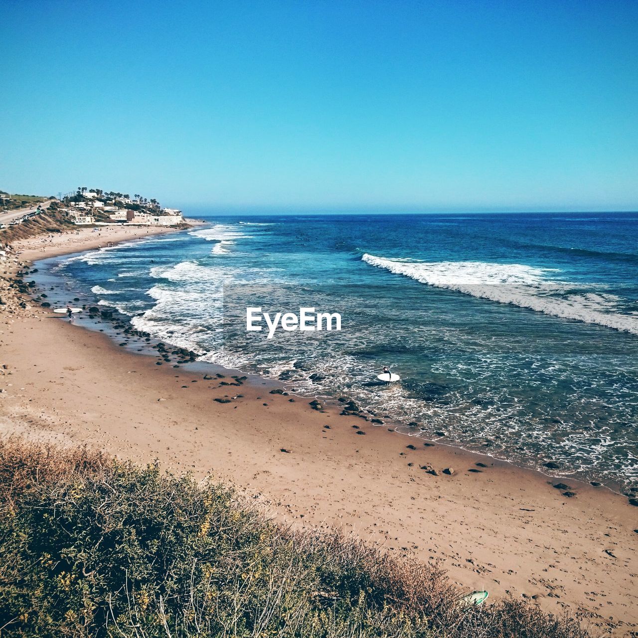 Scenic view of beach against clear sky