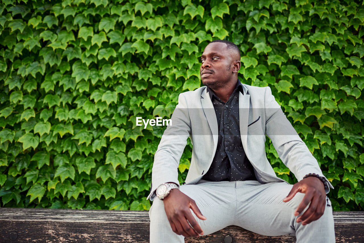 African american man sitting on a park bench.