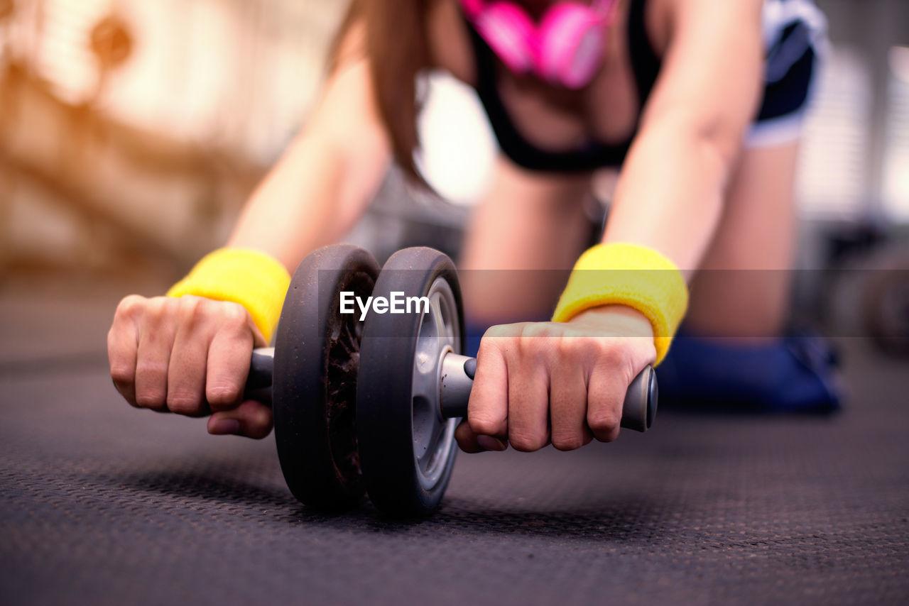 Midsection of woman exercising in gym