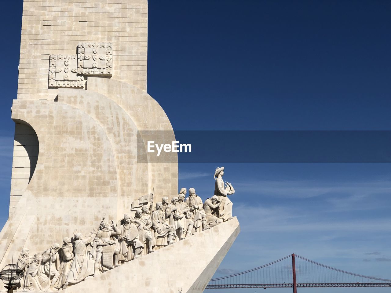 Low angle view of statue against blue sky padrao dos descobrimentos, lisbon, portugal