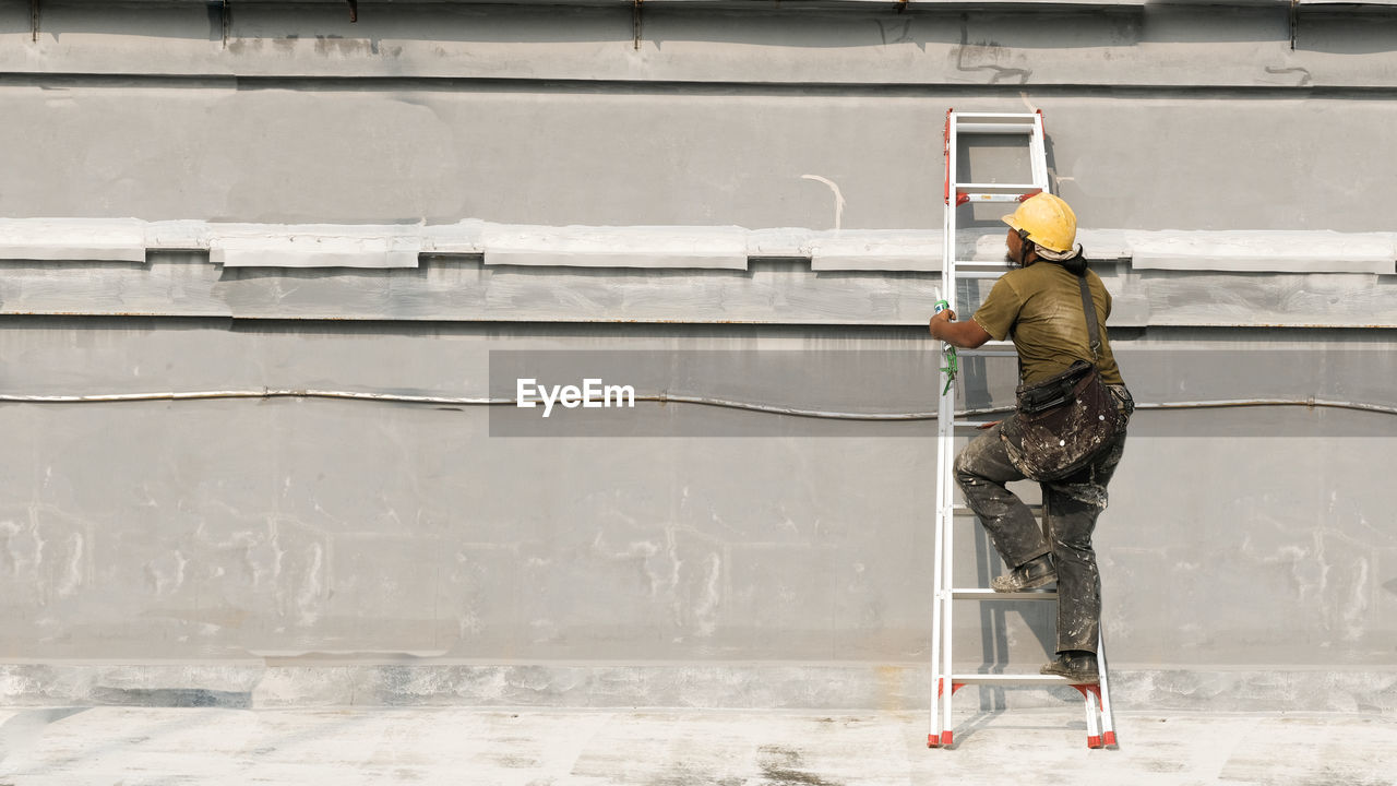 Man working on wall