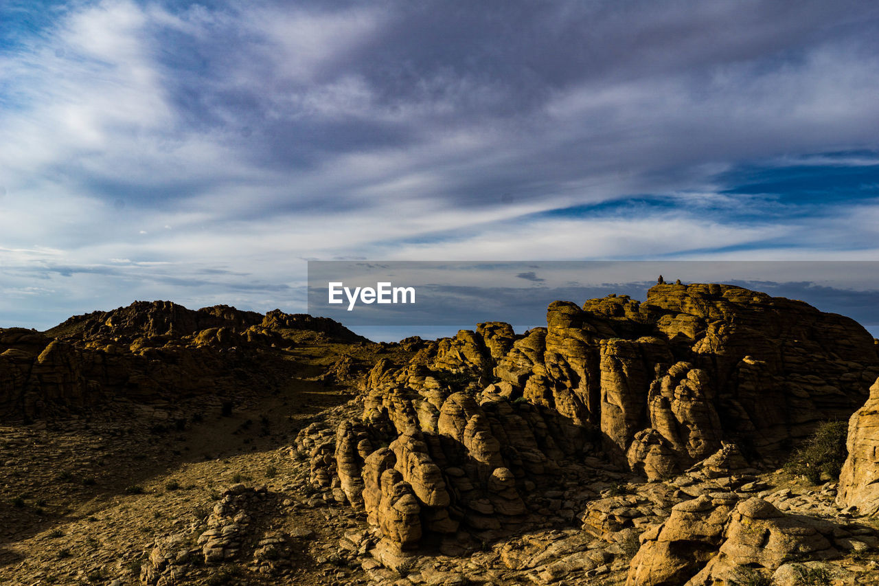 Rock formations on landscape against sky