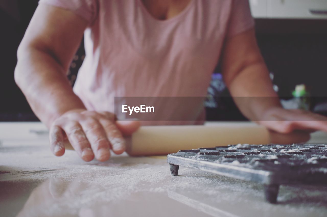 Close-up of hands working in kitchen