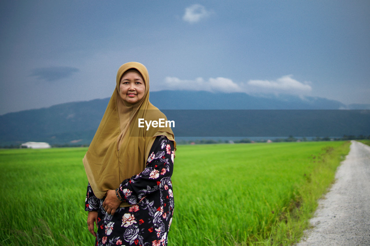 WOMAN STANDING ON FIELD