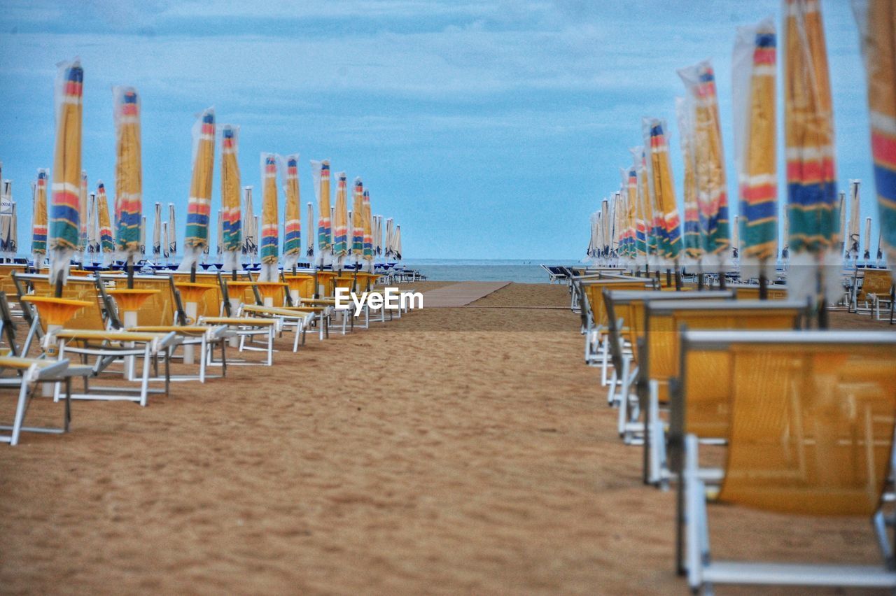 Panoramic shot of chairs on beach against sky