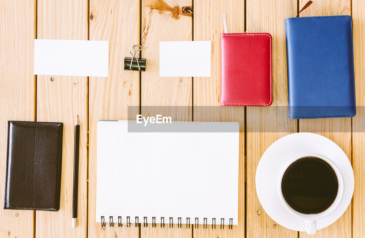 DIRECTLY ABOVE SHOT OF COFFEE CUP ON TABLE AGAINST WALL