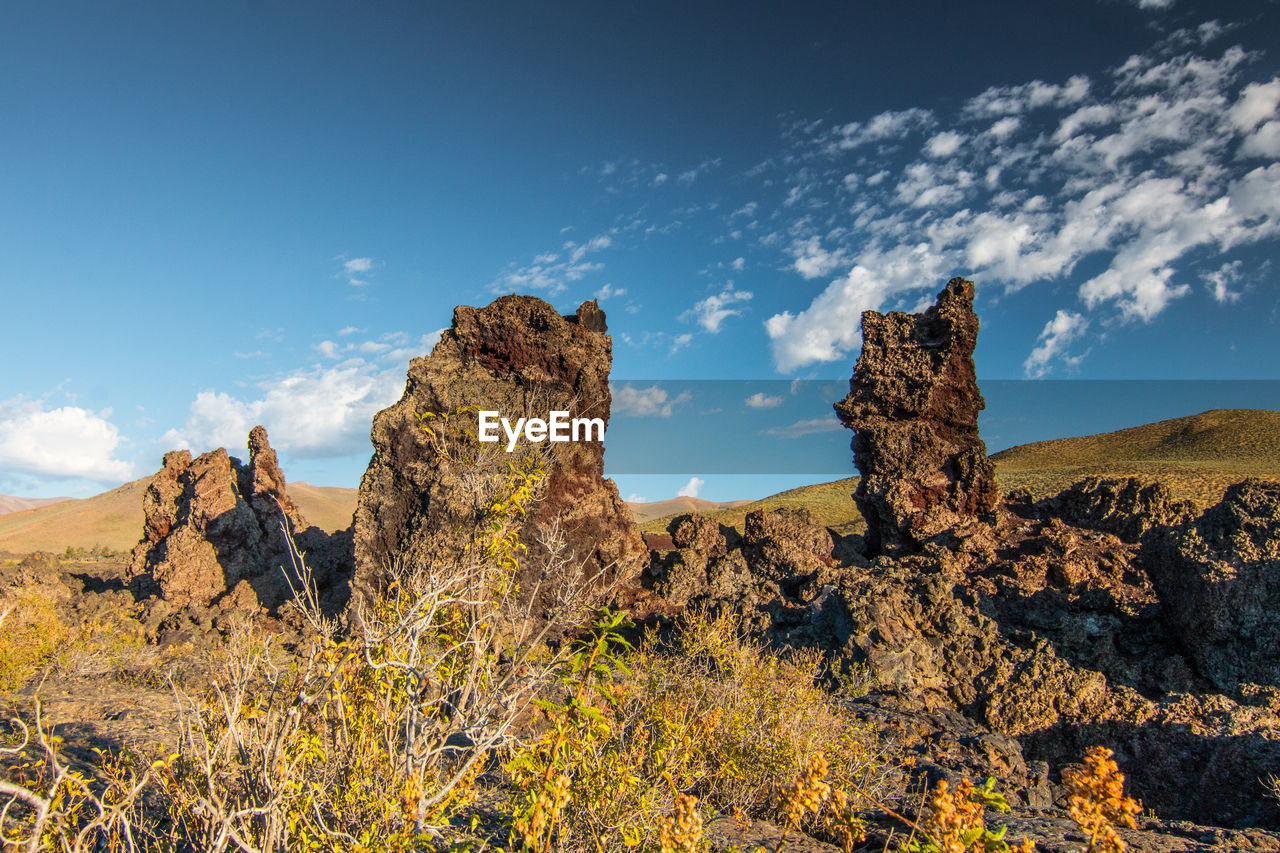 Rock formations on landscape against sky