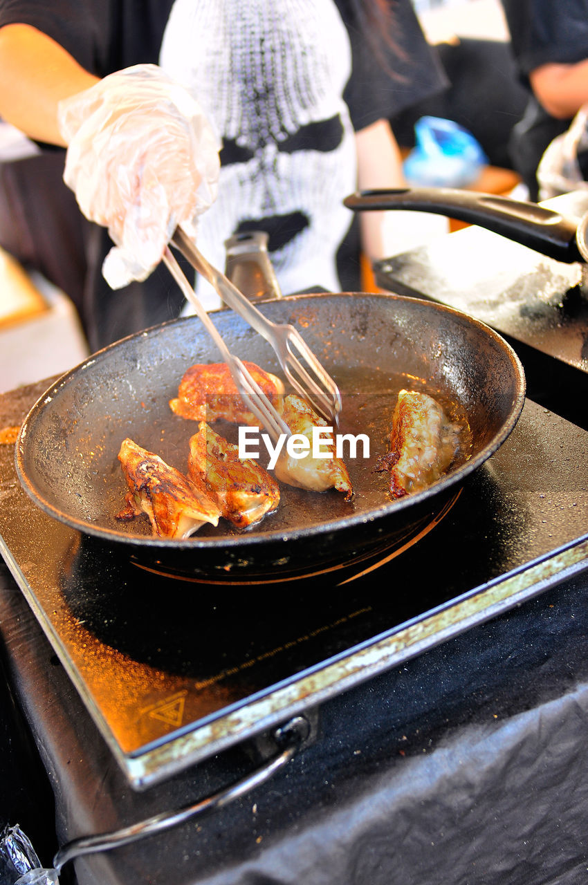 cropped image of man preparing food in kitchen