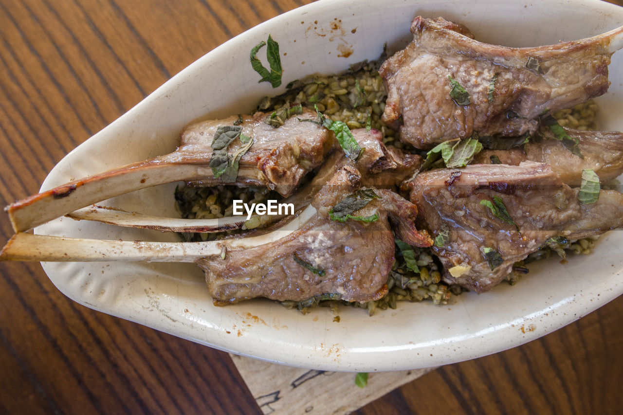 Close-up view of lebanese lamb chops and fresh mint with freekeh