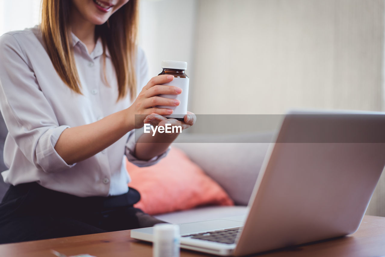 Asian female medical assistant making a video call with patients for online support