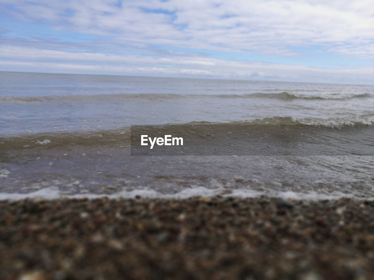 CLOSE-UP OF BEACH AGAINST SKY