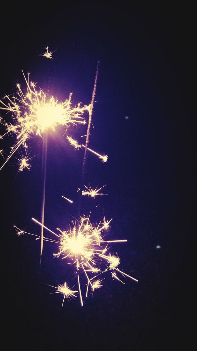 LOW ANGLE VIEW OF FIREWORK DISPLAY AT NIGHT