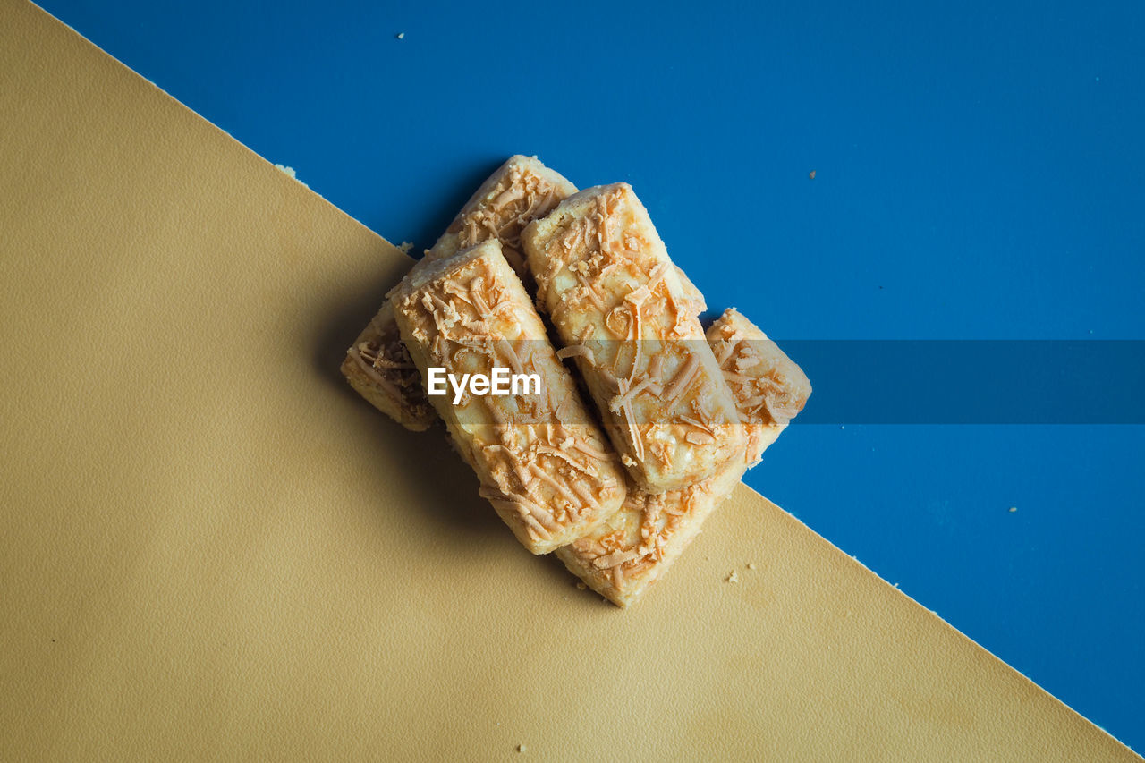 High angle view of cookies on blue and yellow  background 