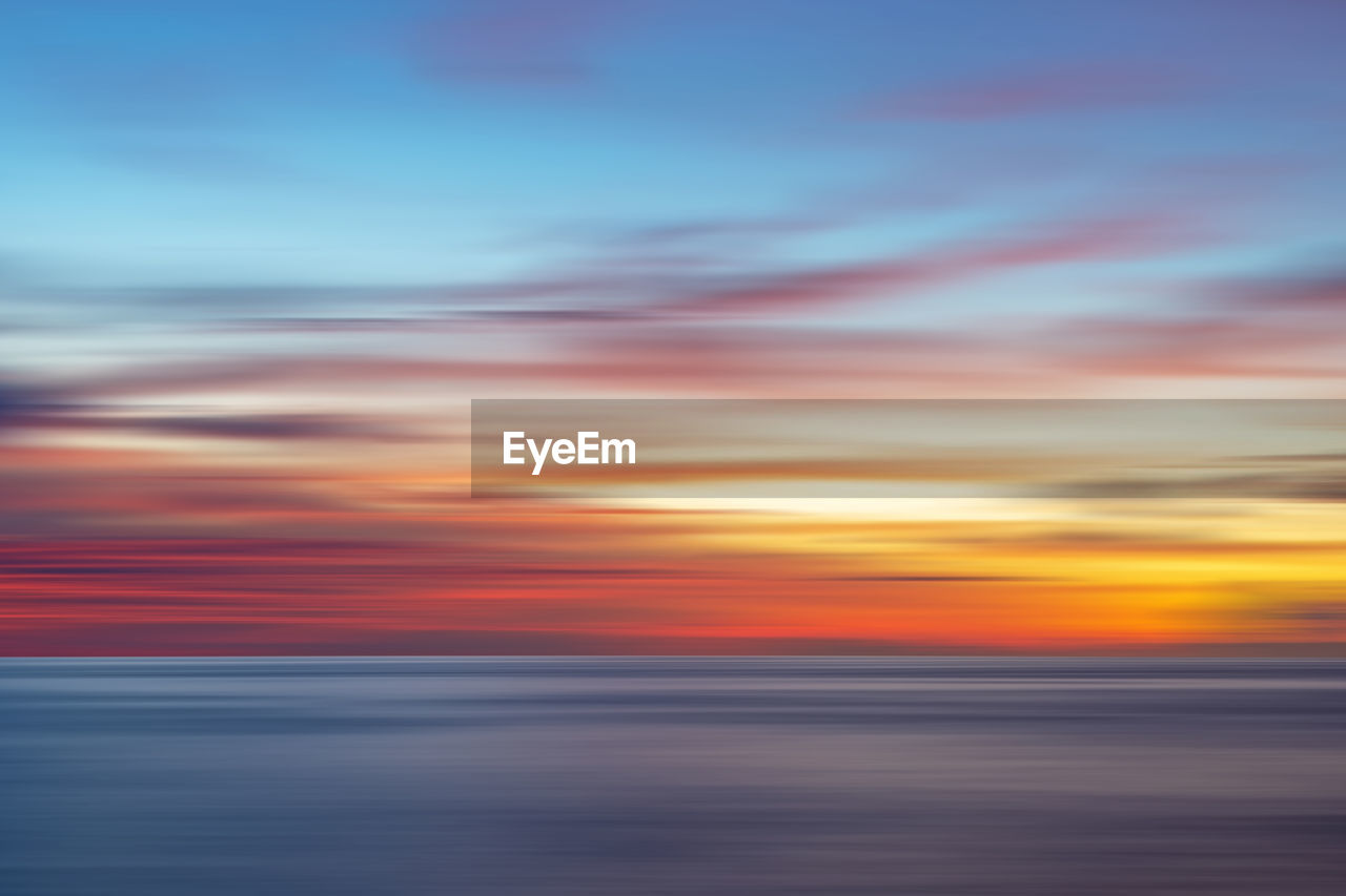 Scenic view of sea against romantic sky at sunset