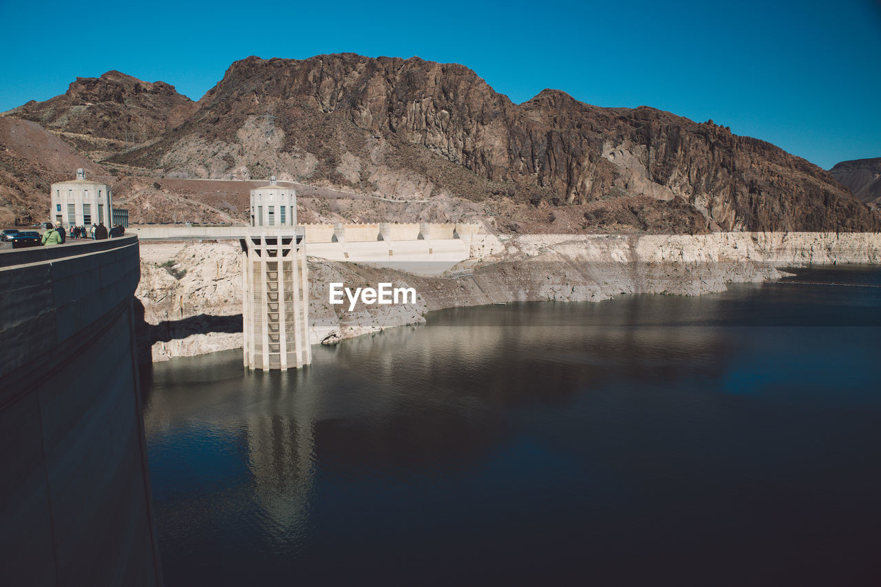 Scenic view of river against mountain range