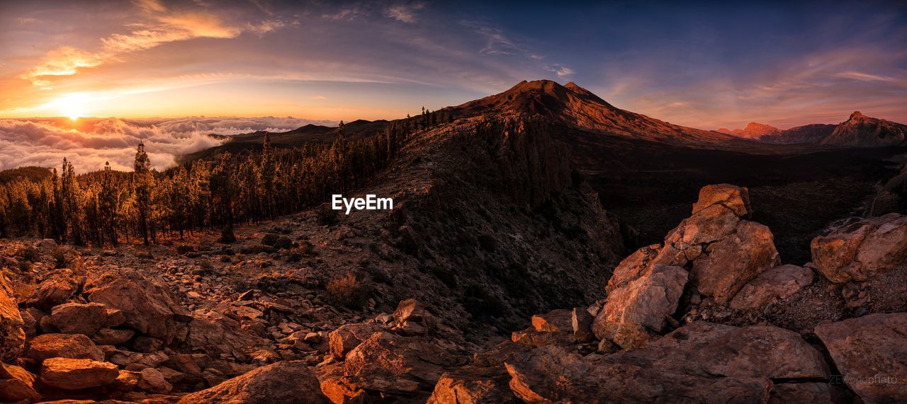 Scenic view of rocky mountains against sky during sunset