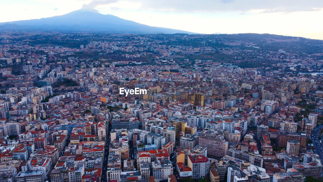 The city of catania and mount etna from a bird's eye view. sicily, italy