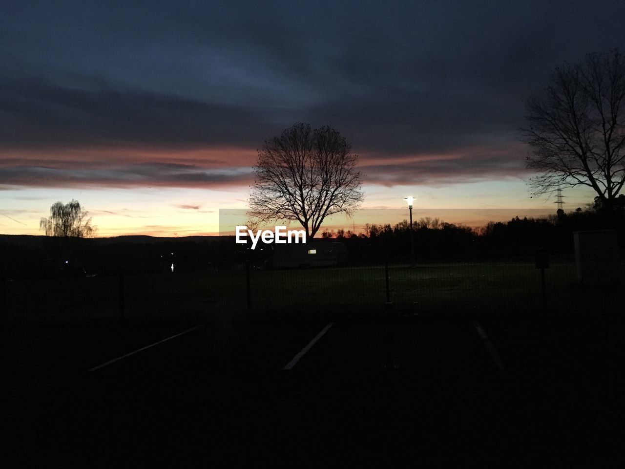 SILHOUETTE OF BARE TREES AGAINST SKY DURING SUNSET