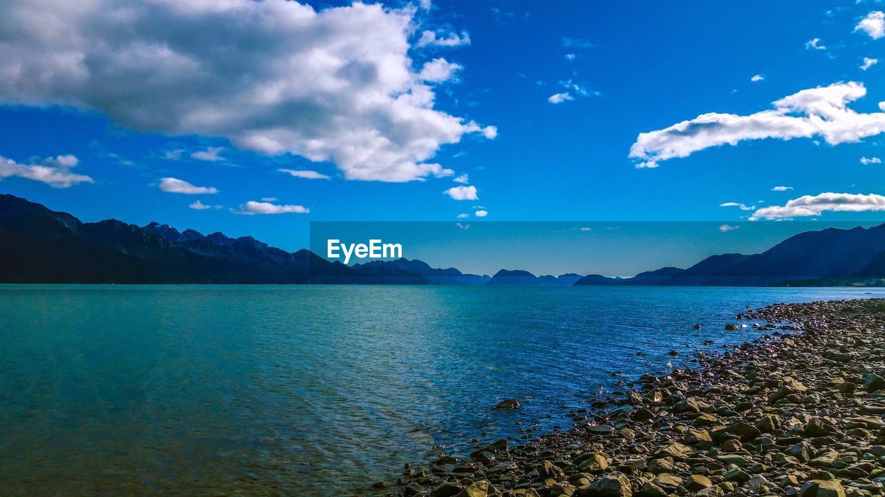 Scenic view of sea against blue sky