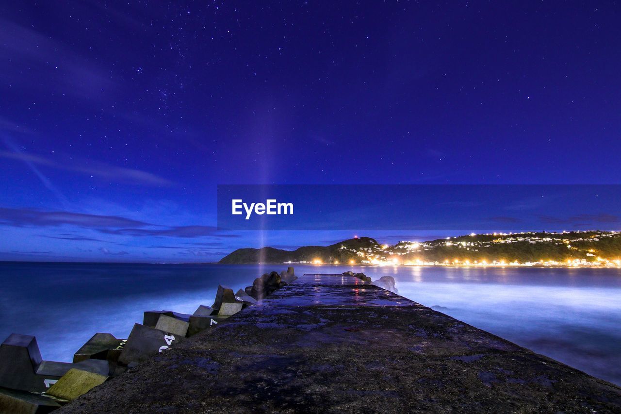 Scenic view of sea against sky at night