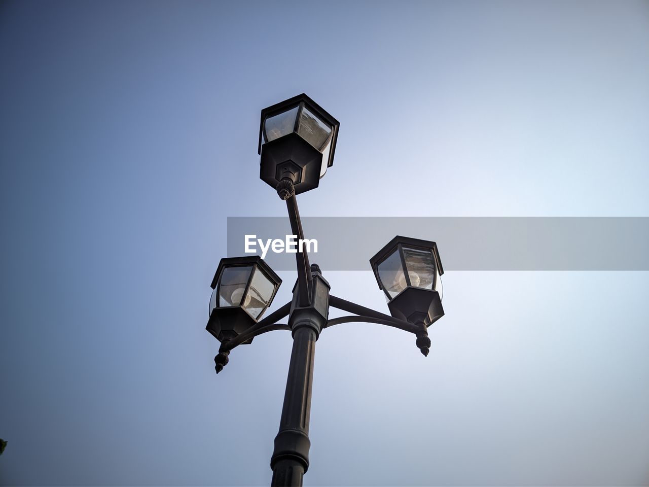 Low angle view of security camera against clear sky