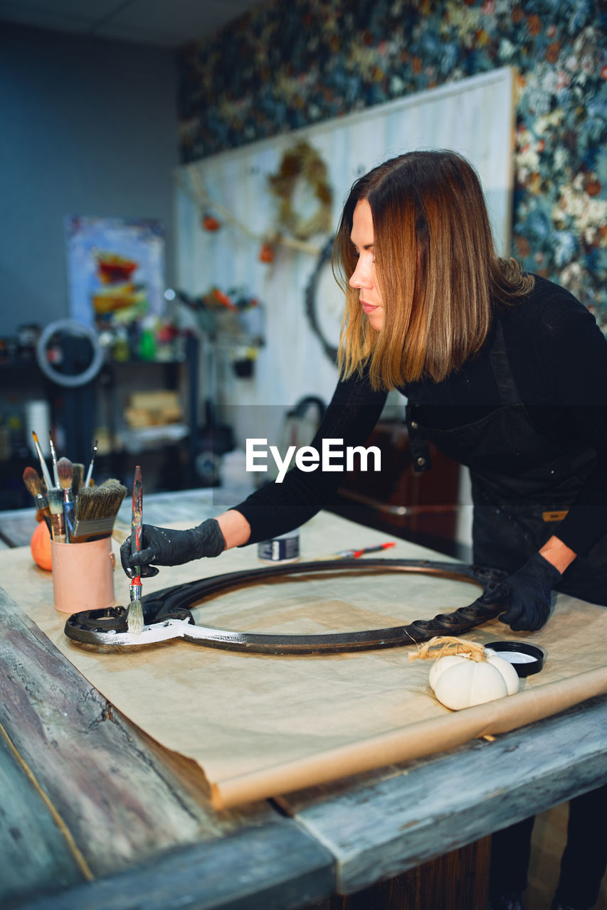 Woman painting on table