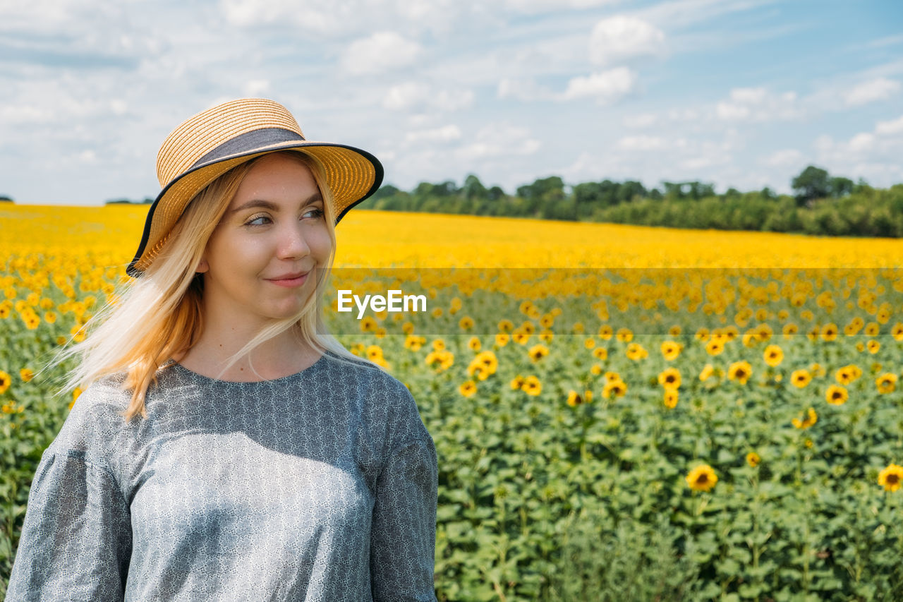 Ukrainian girl young woman on the background of sunflowers field. ukraine sunflowers national