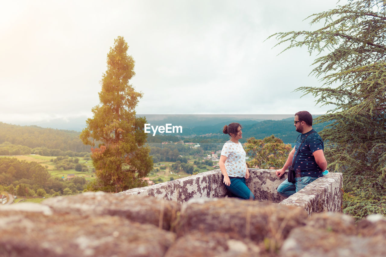 Couple talking while standing on observation point