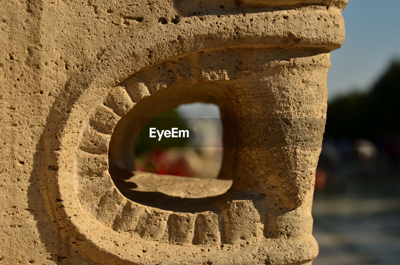 CLOSE-UP OF WEATHERED HOLE IN WALL