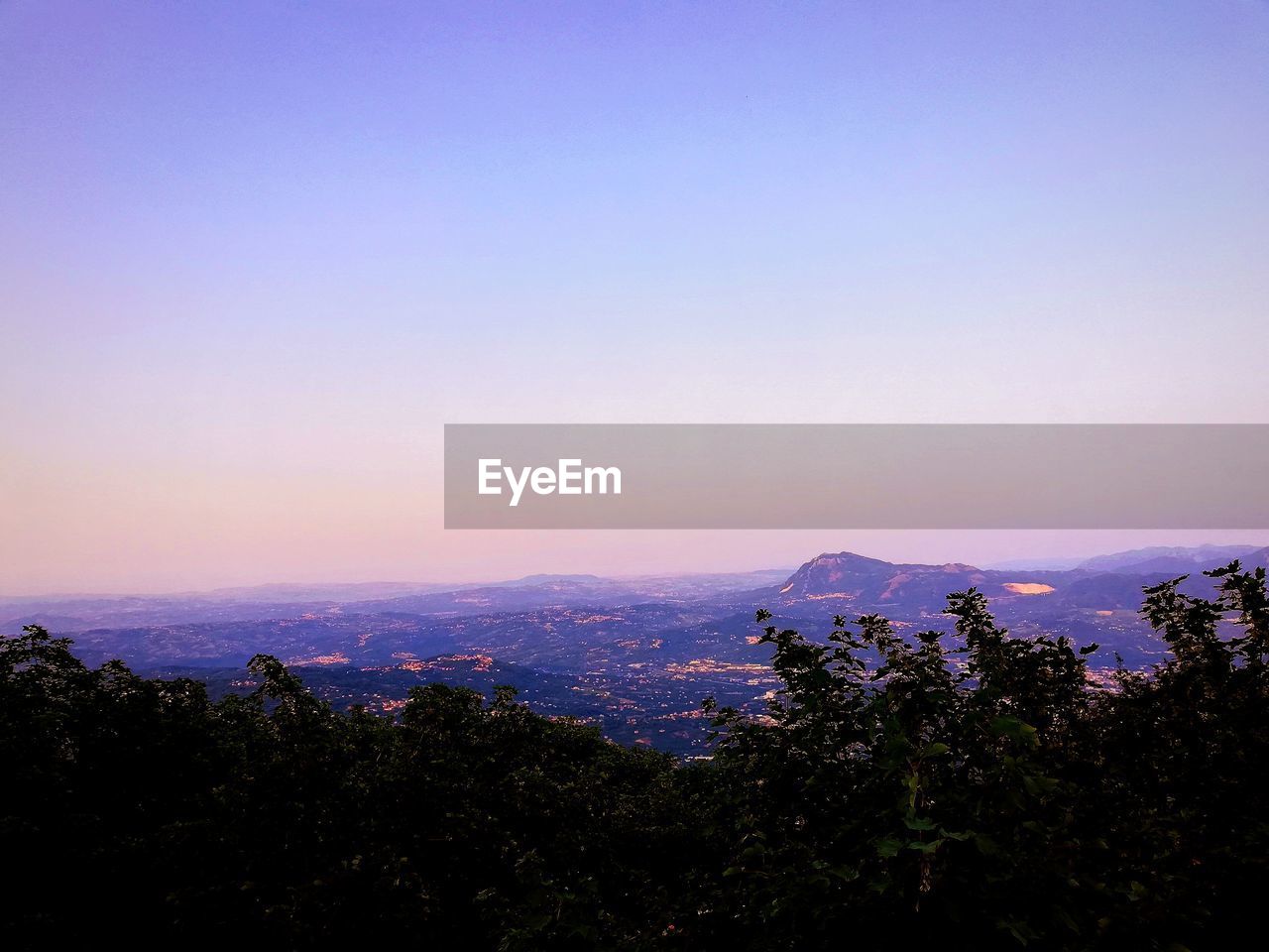 Scenic view of silhouette mountains against sky at sunset