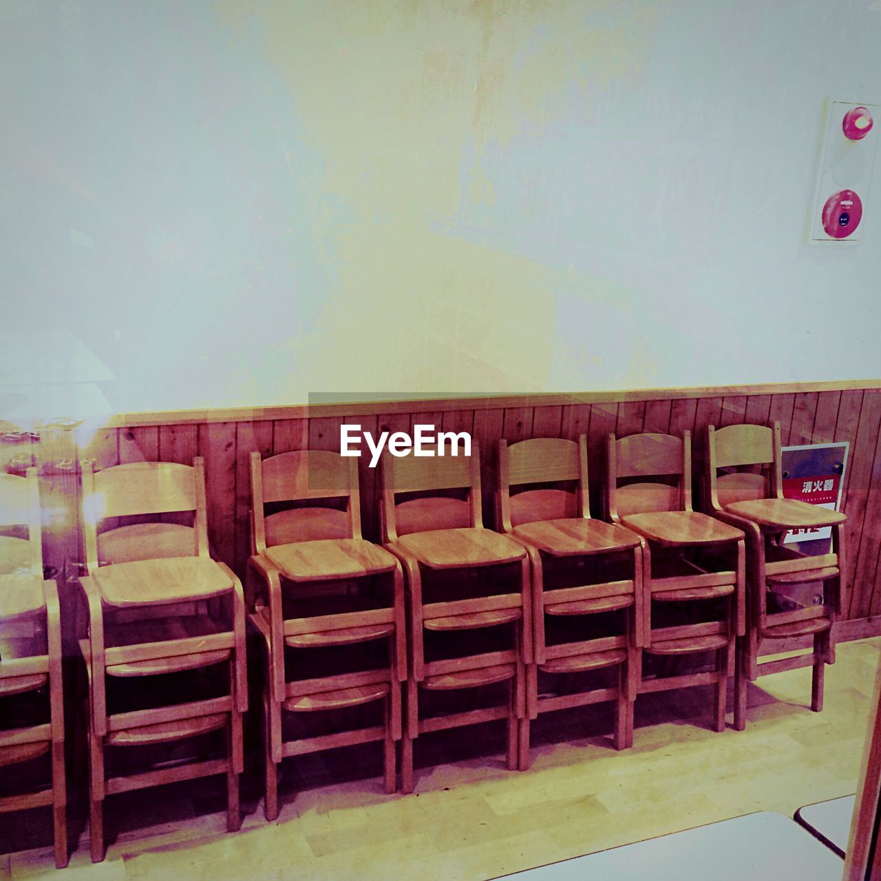 Stack on chairs against wall in building