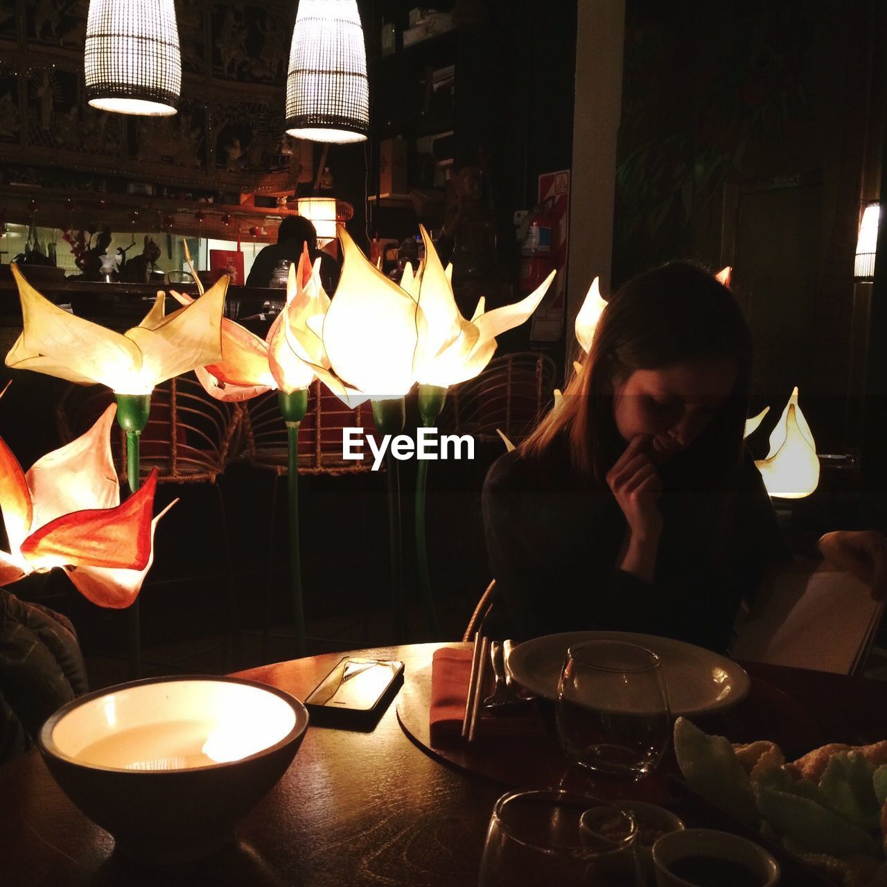 WOMAN SITTING ON RESTAURANT