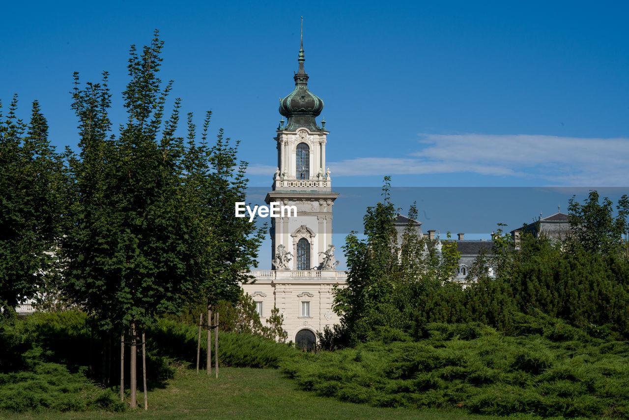 View of building and trees against sky