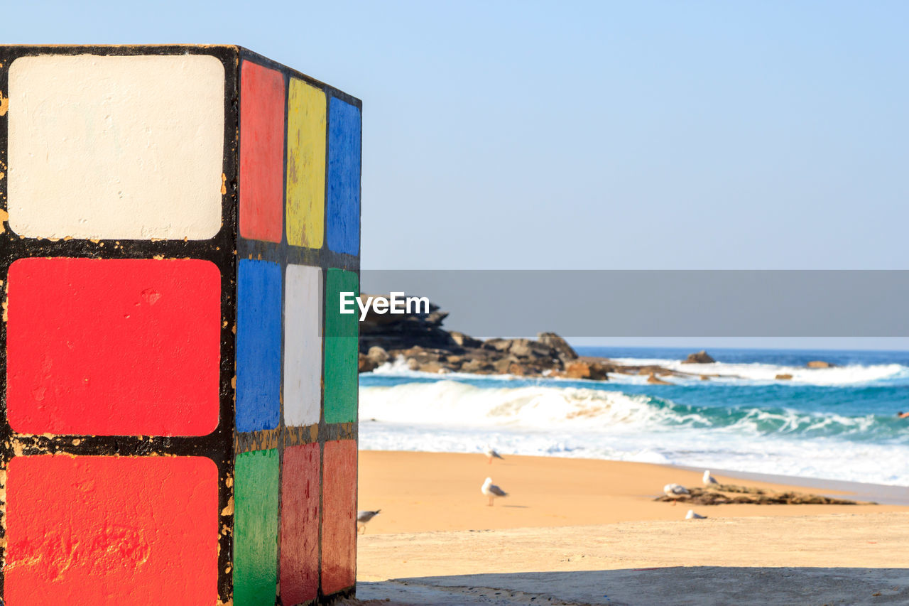 Close-up of multi colored beach against clear sky