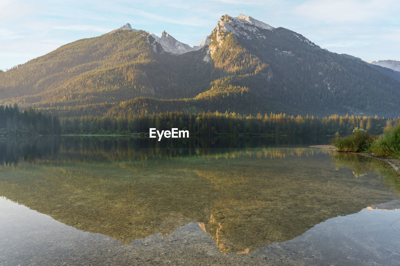 Majestic mountain reflected in still alpine lake during sunrise, hintersee, germany