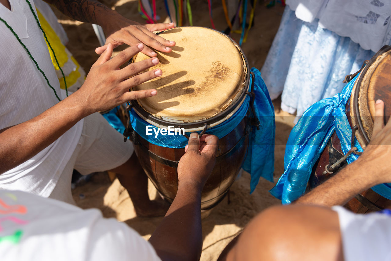 Percussionist hands playing atabaque.