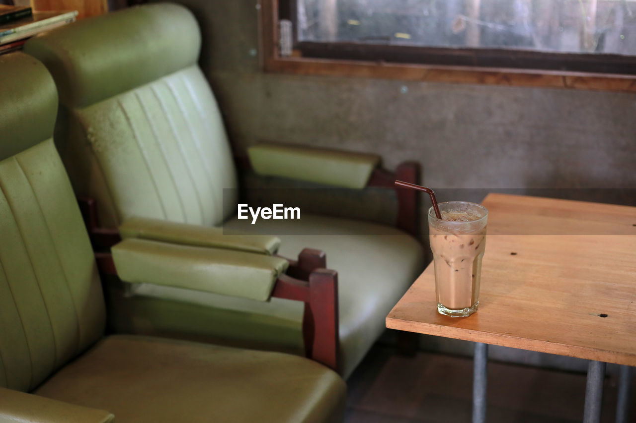 Iced coffee and seating furniture in restaurant