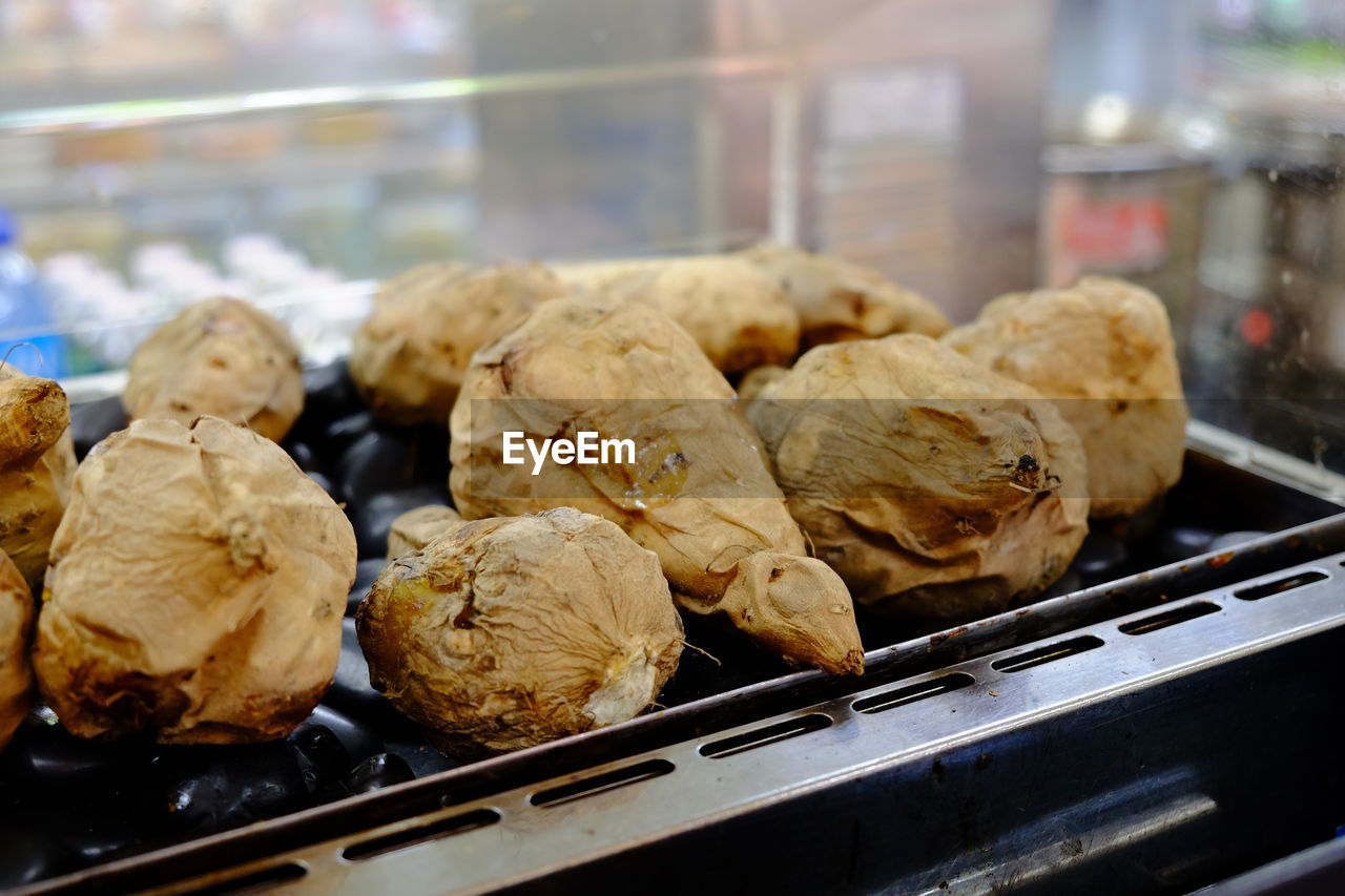 Close-up of baked sweet potatoes on grill